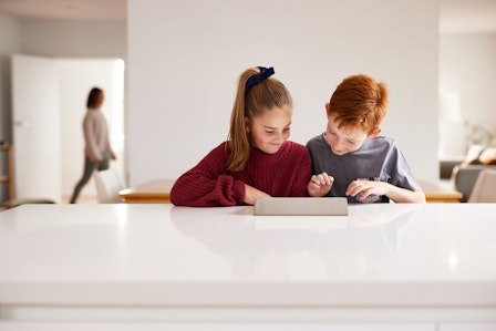 Two children looking at device 