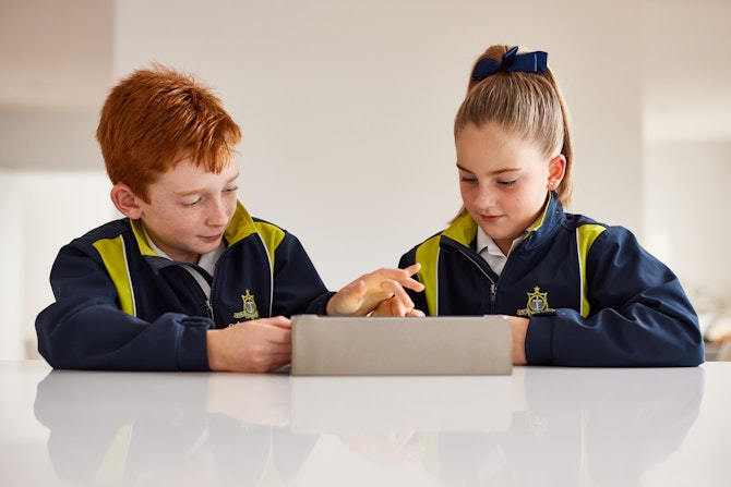 Children using their tablet devices.