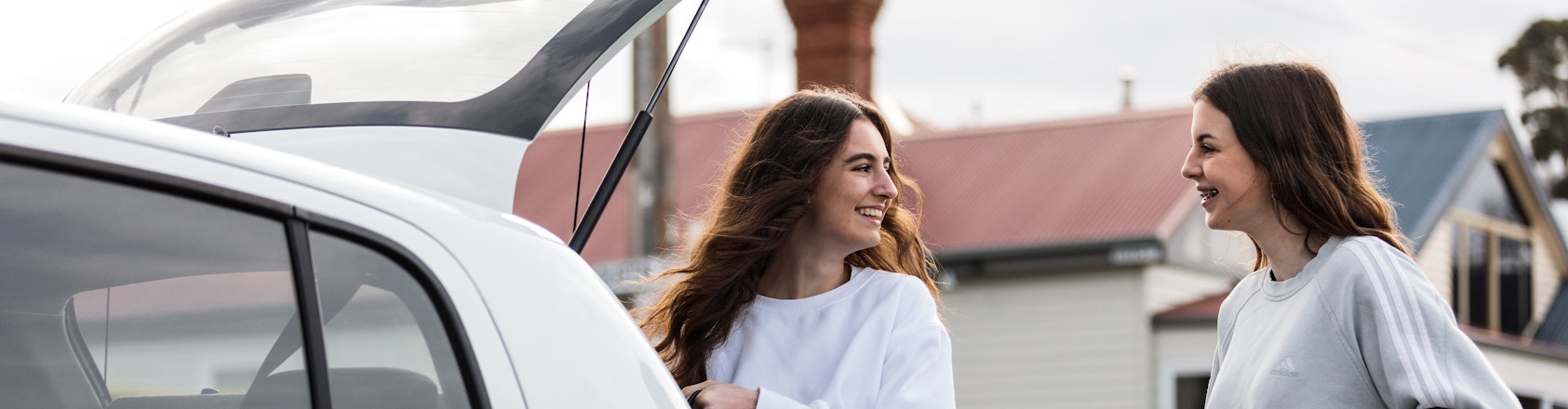 Young girls packing the car