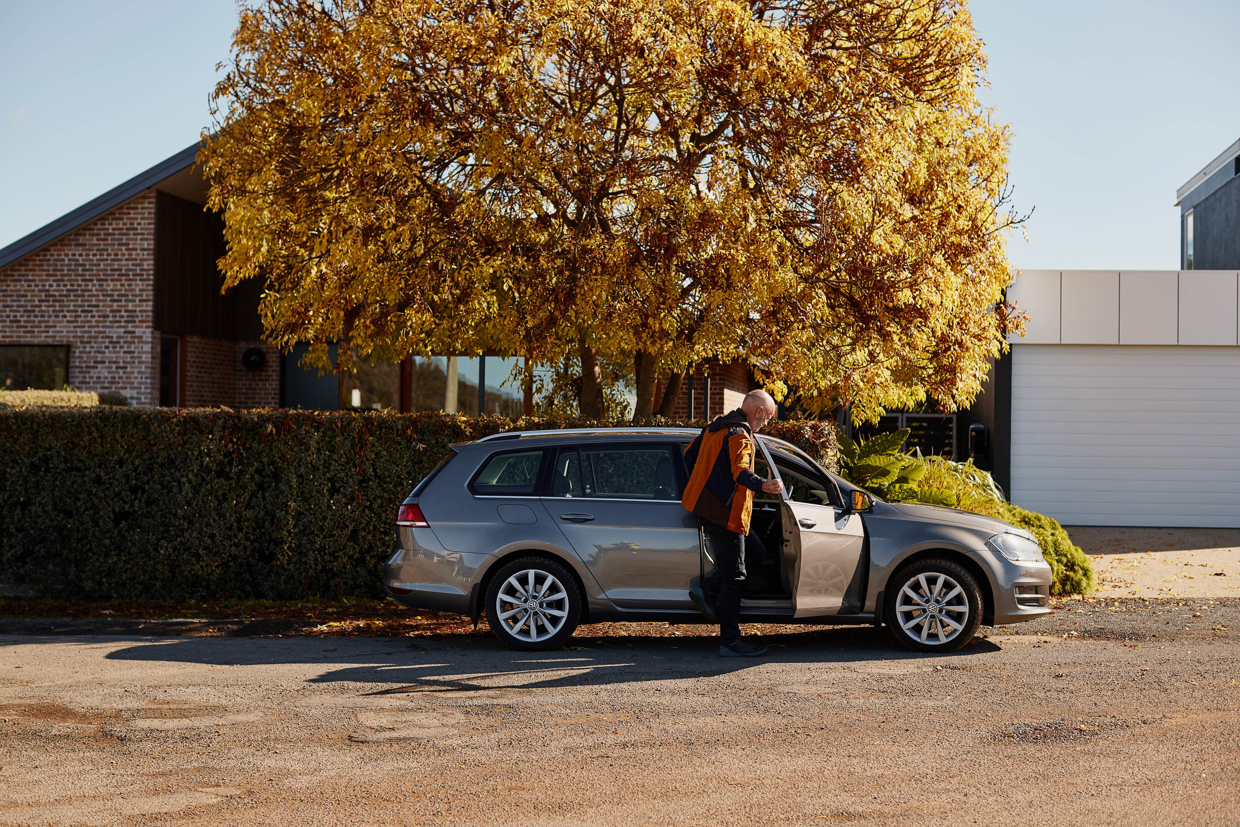 Man getting in to his car outside home