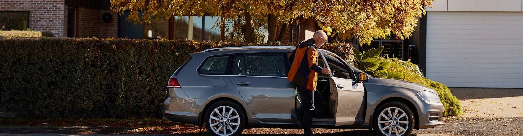 Man getting in to his car outside home