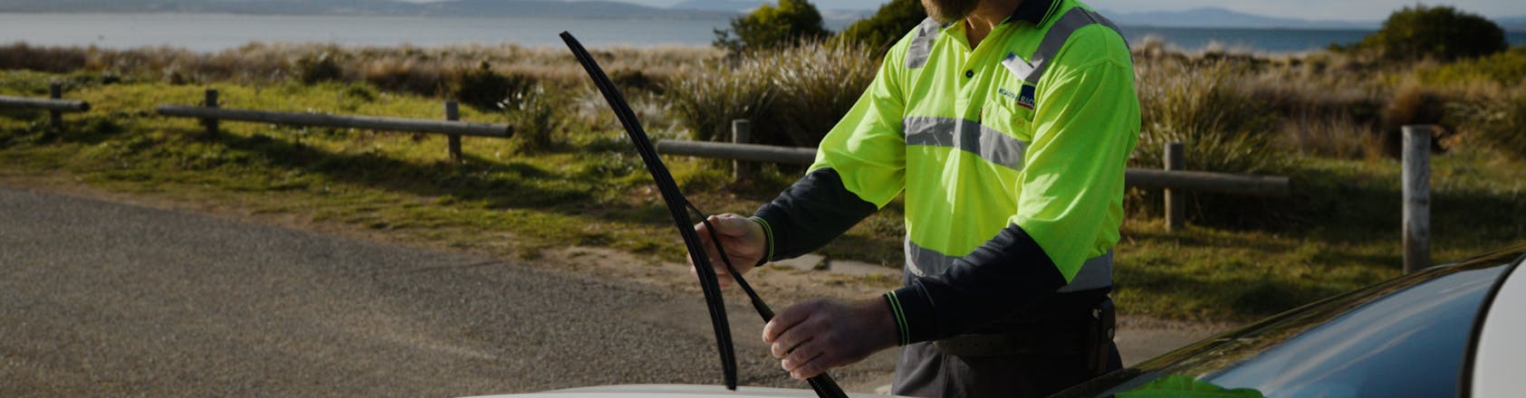 roadside patrol inspecting car windscreen wiper