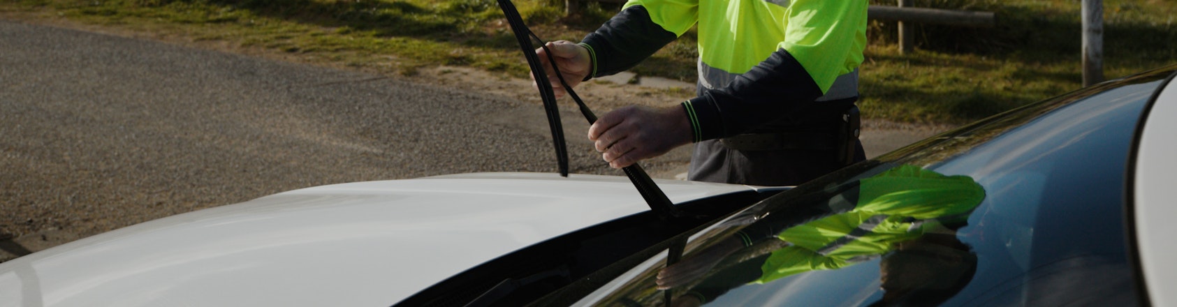 roadside patrol inspecting car windscreen wiper