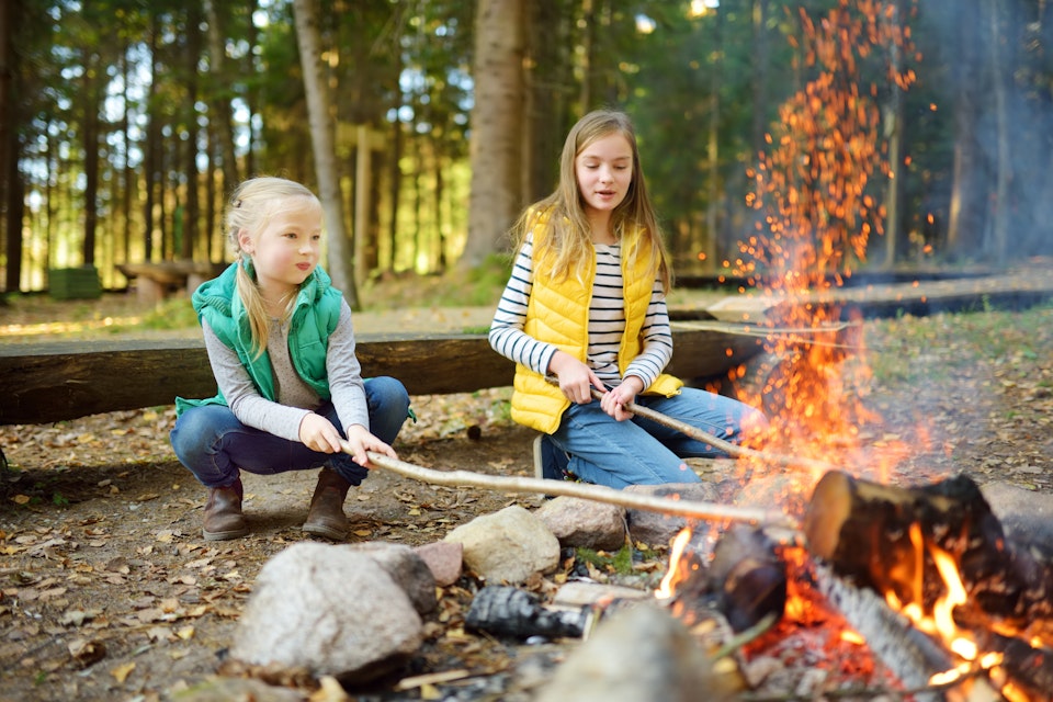 Girls near camp fire