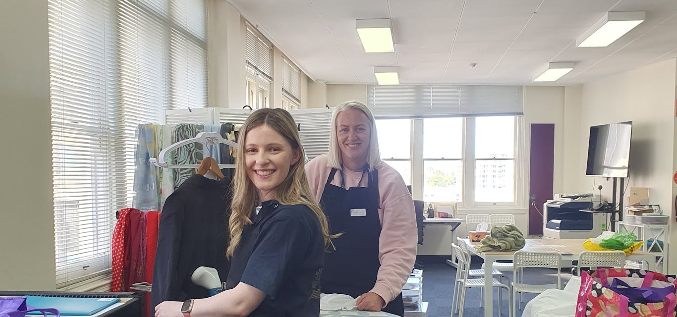 Leah and Gen giving some items a steam clean RACT team at Dress for Success boutique
