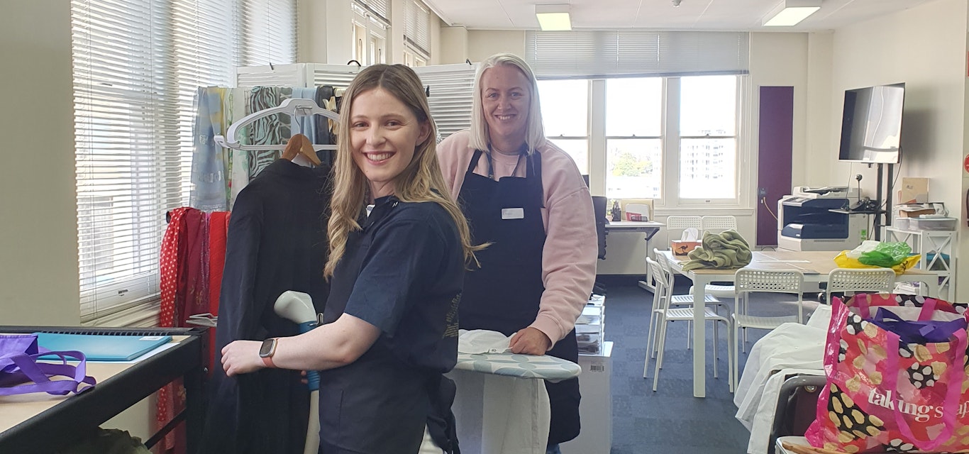 Leah and Gen giving some items a steam clean RACT team at Dress for Success boutique