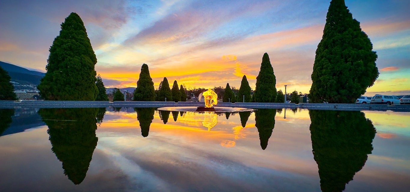 a fiery sunset at the Flame of Remembrance and Pool of Reflection in Queens Domain, Hobart