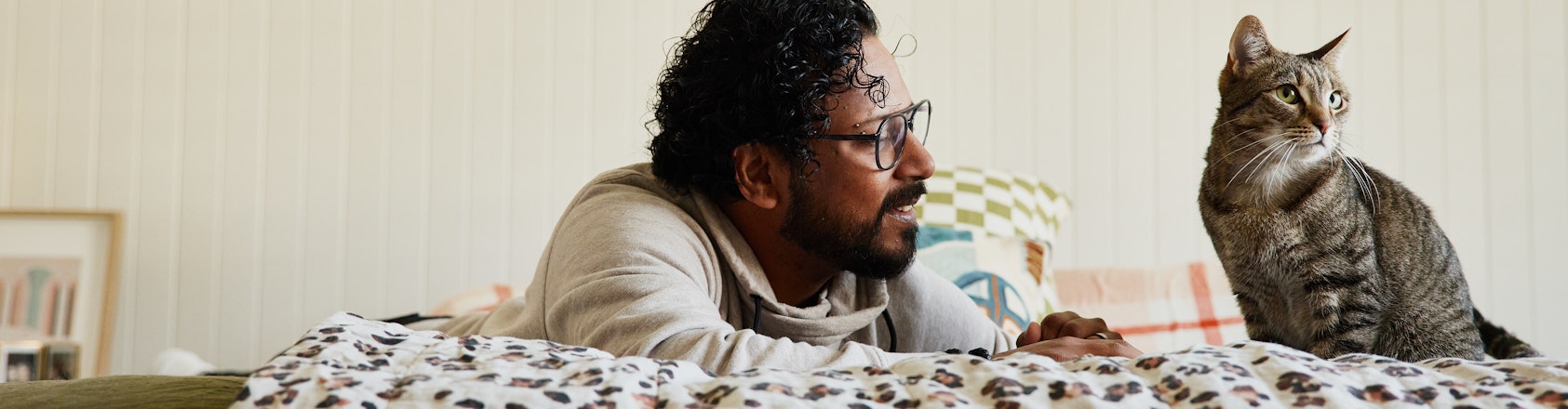 Man laying on bed with cat