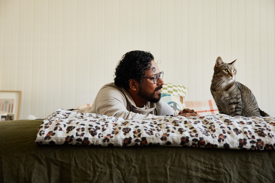 Man laying on bed with cat