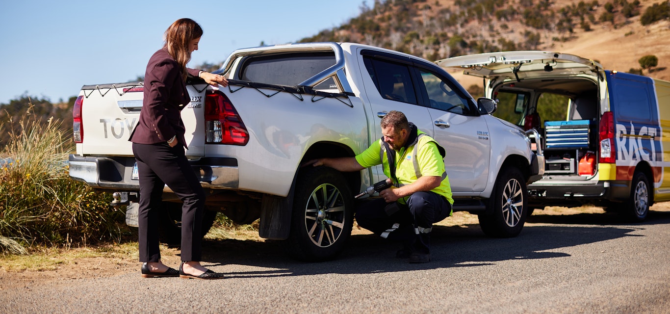 Roadside patrol helping a woman on the side of the road