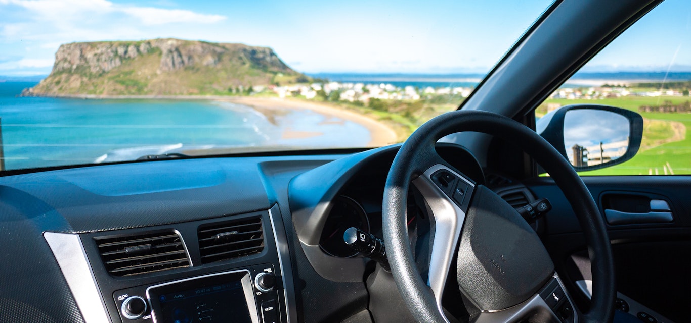 The inside of a car and looking out to the view of Tasmania
