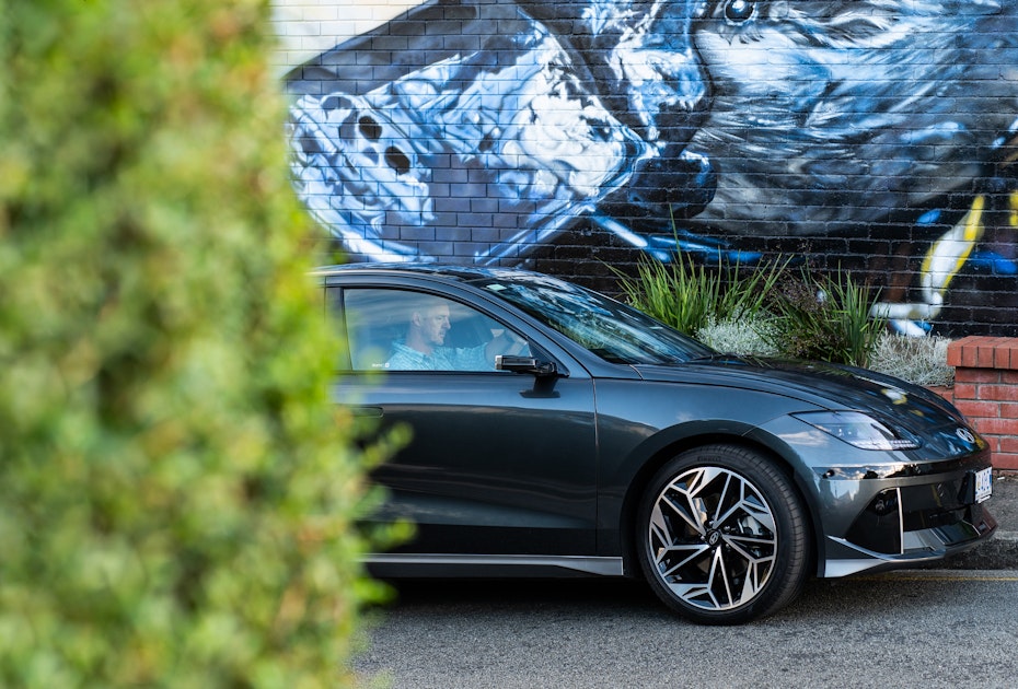 The IONIQ 6 stands out against a backdrop of murals in South Hobart