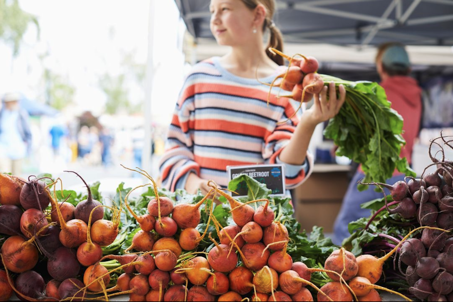 Checking out the produce at Harvest Market, Launceston