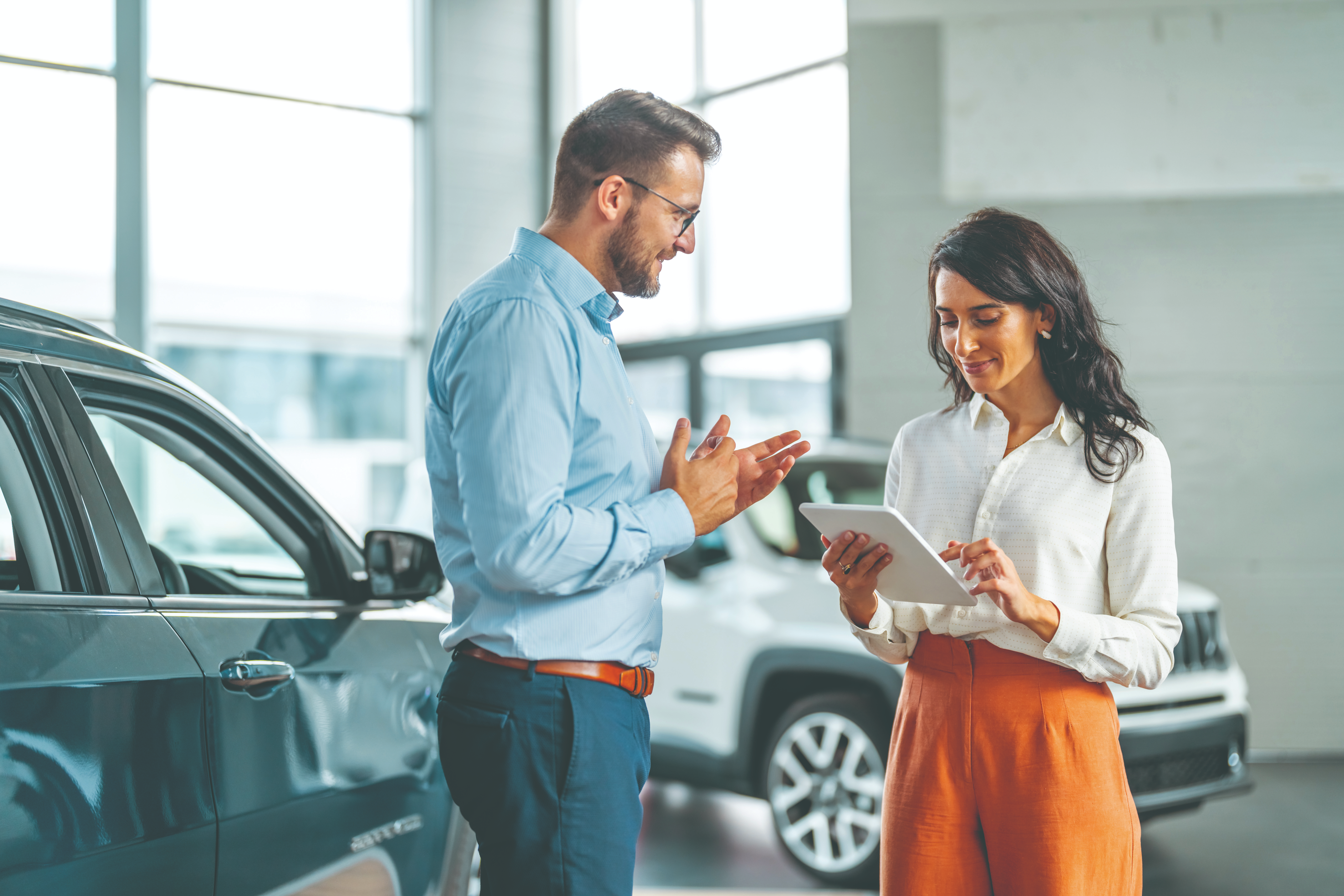 Man and woman in a car dealership