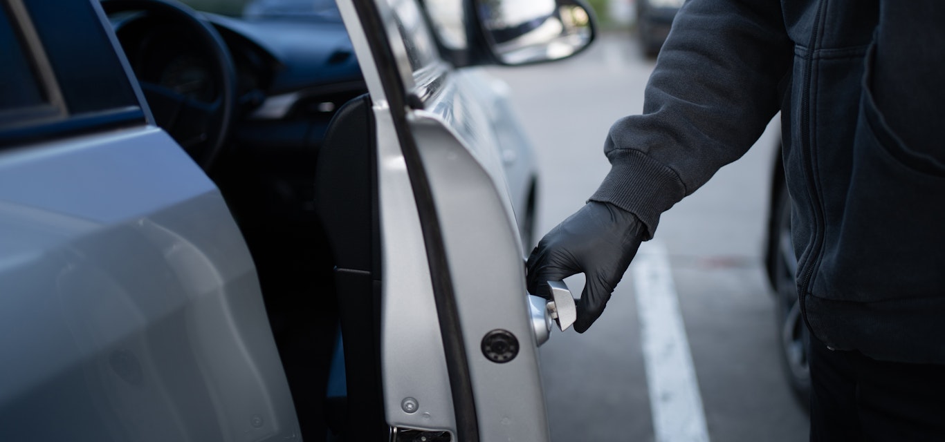 gloved hand opening car door