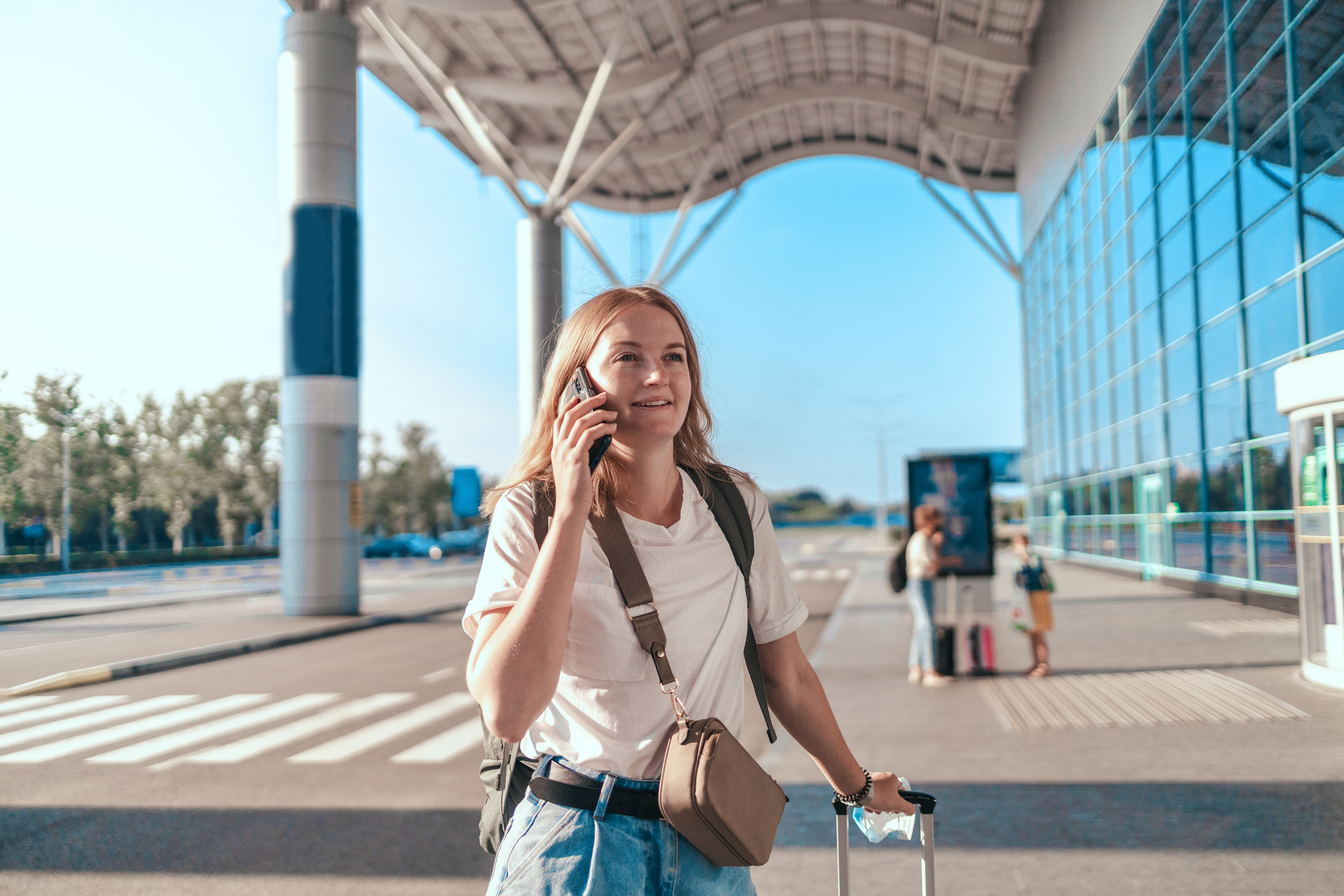 Woman on talking on the phone outside the airport