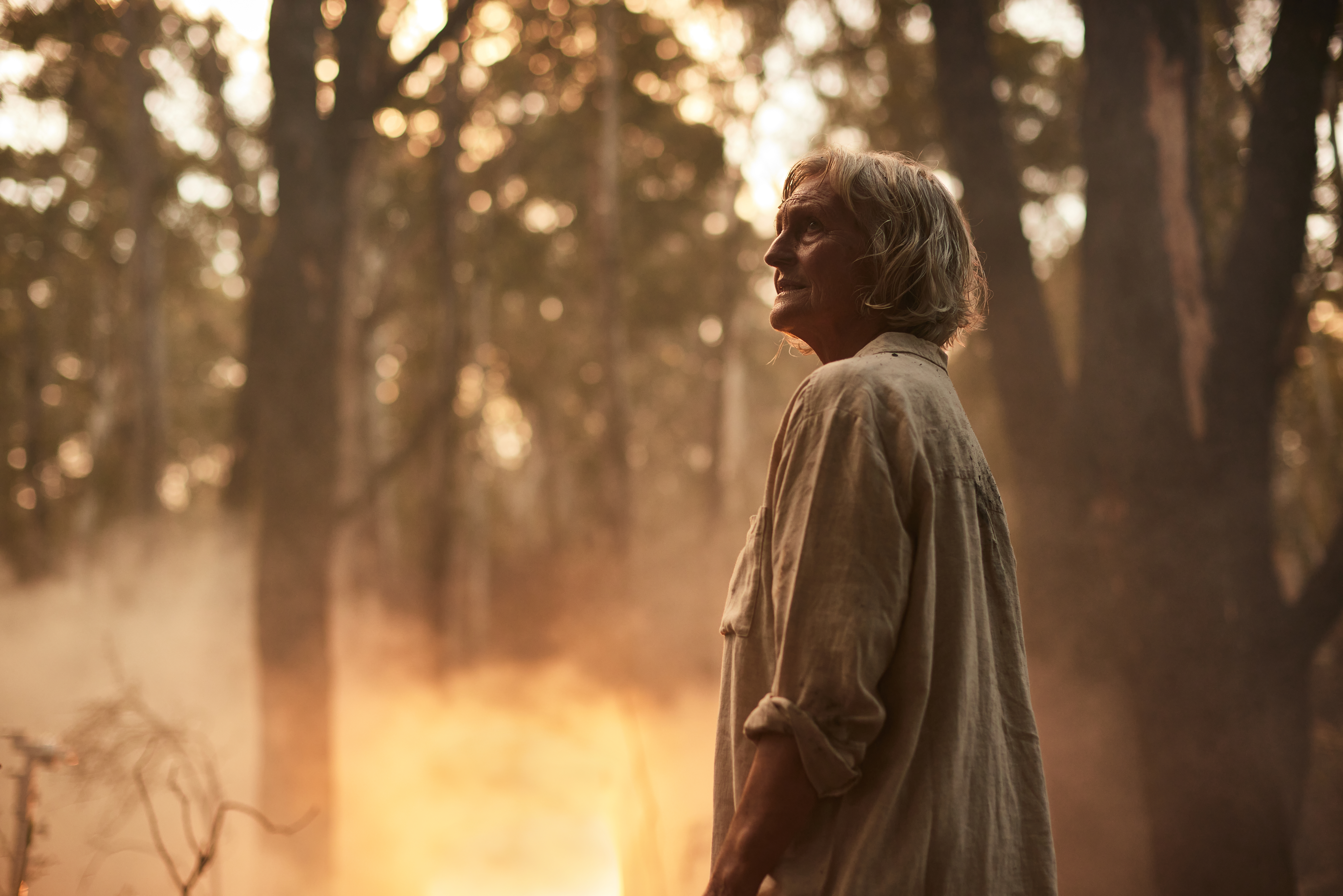 Woman standing near bushfire