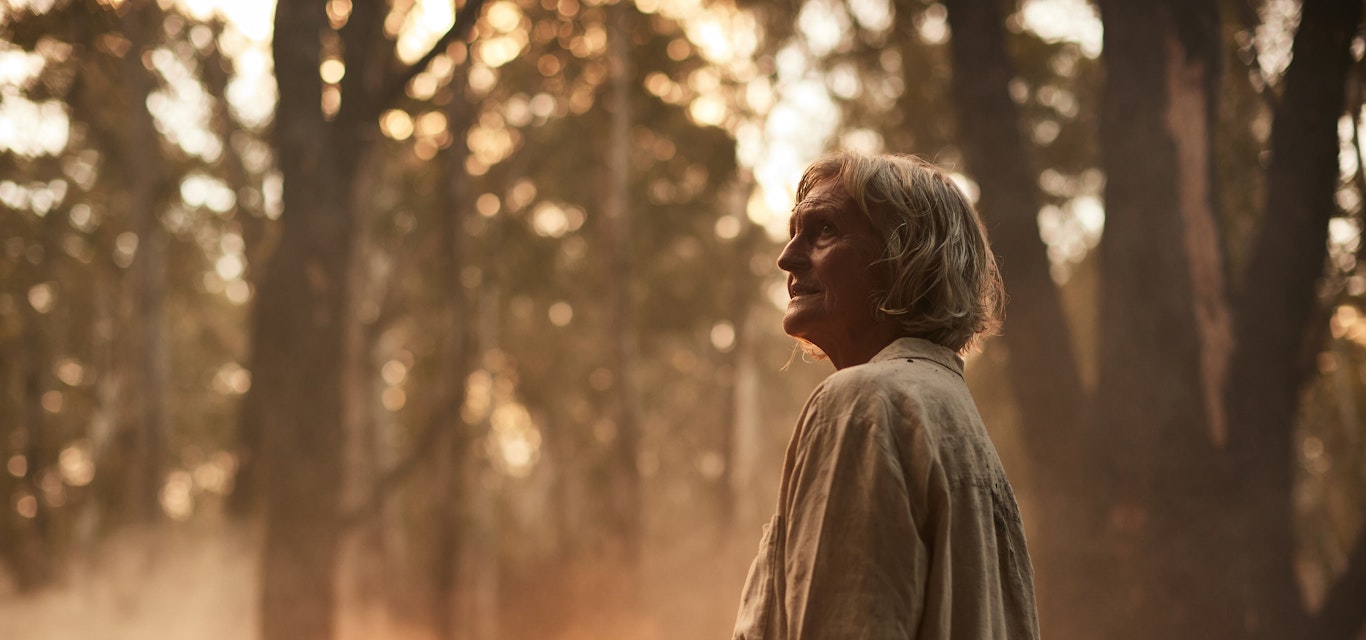 Woman standing near bushfire