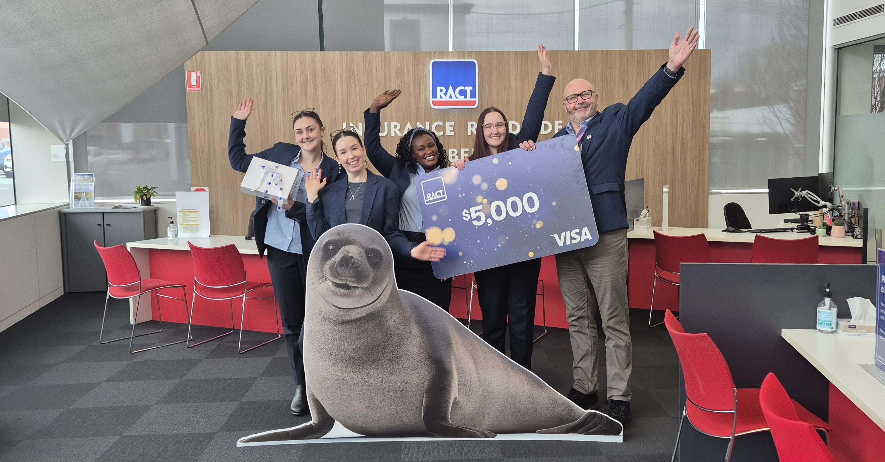 RACT staff with winner's $5,000 novelty cheque
