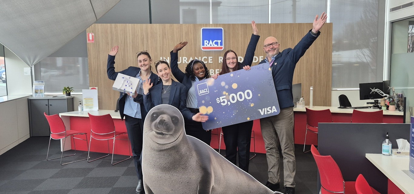 RACT staff with winner's $5,000 novelty cheque