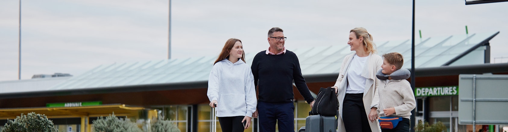 Man sitting on bed, packing suitcase ready for travel