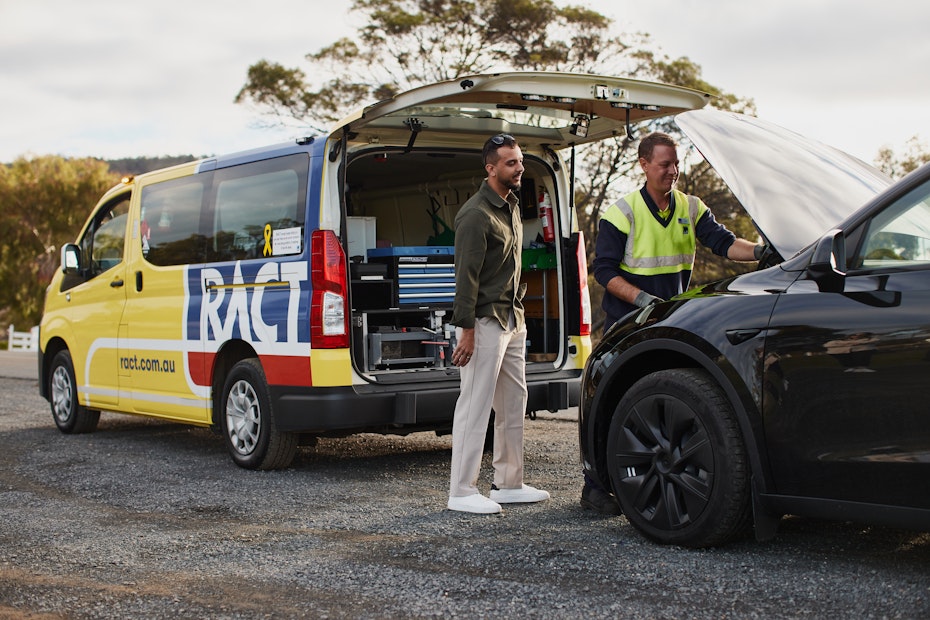 A RACT Roadside patrol man helps a member with a black car.
