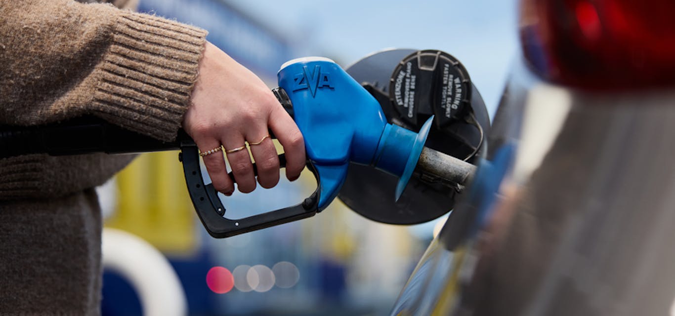 Lady filling up her car at the fuel station