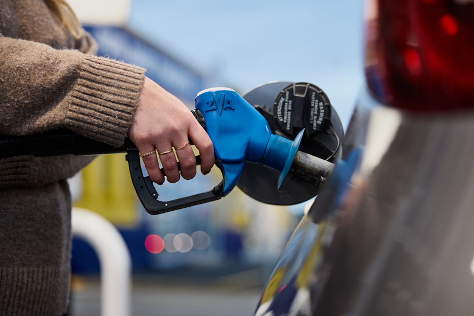 Lady filling up her car at the fuel station