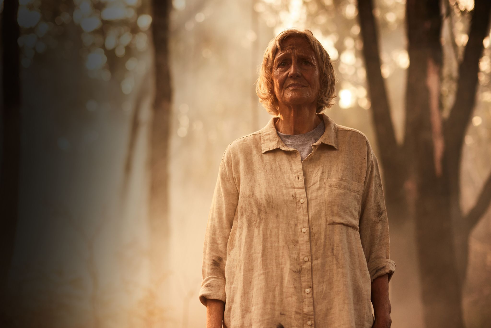 Woman standing amongst bushfire smoke