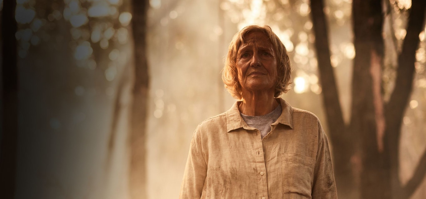 Woman standing amongst bushfire smoke