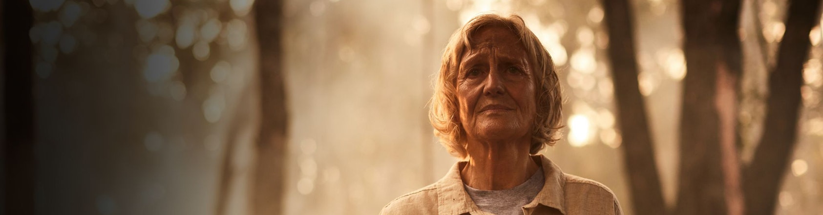 Woman standing amongst bushfire smoke