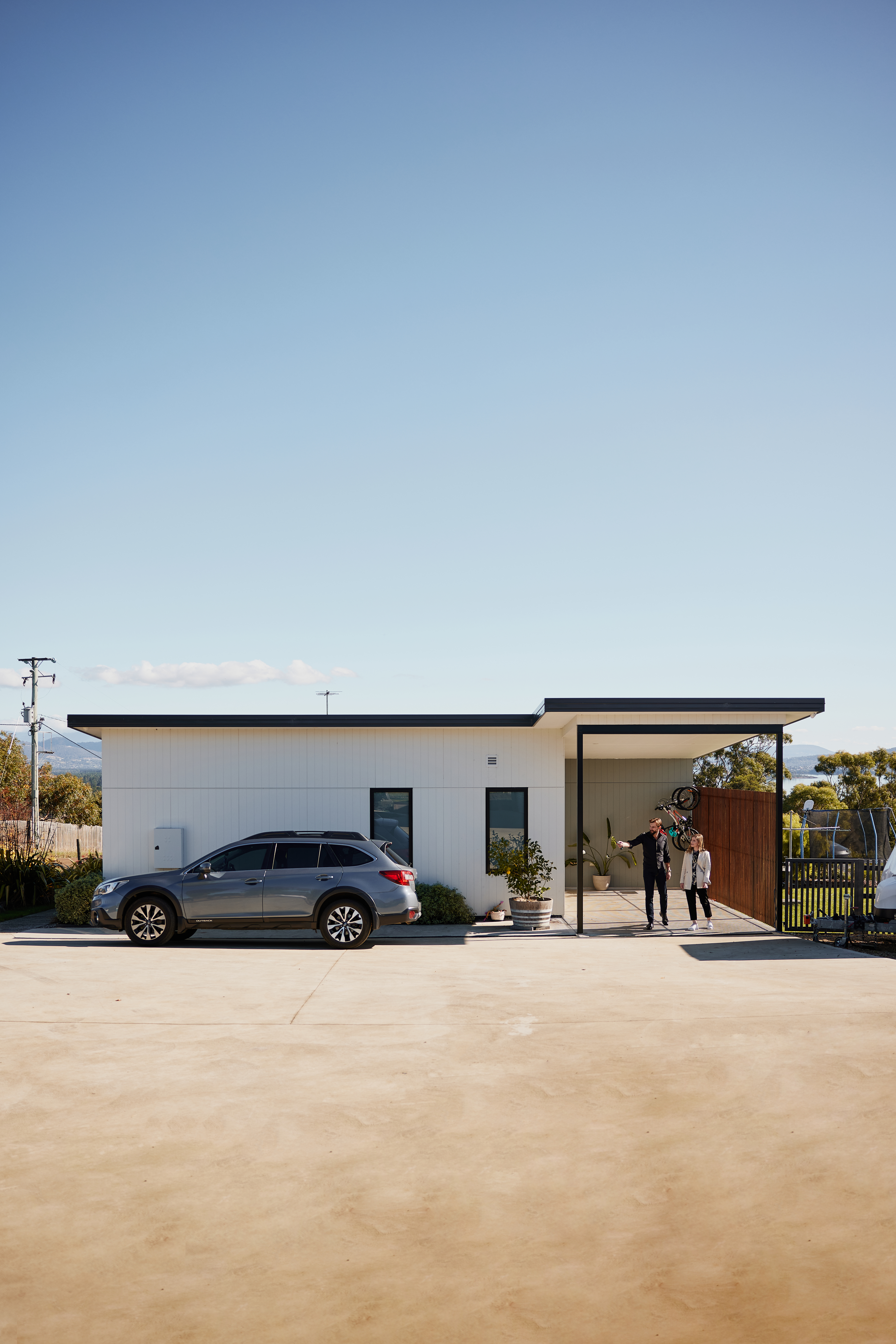 Man and women leaving home and walking to their car
