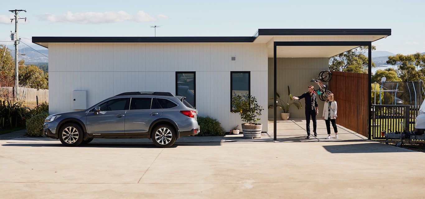 Man and women leaving home and walking to their car