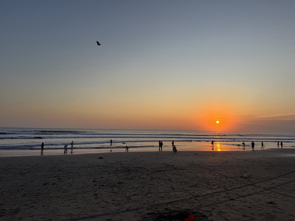 People at sunset on the beach in Bali