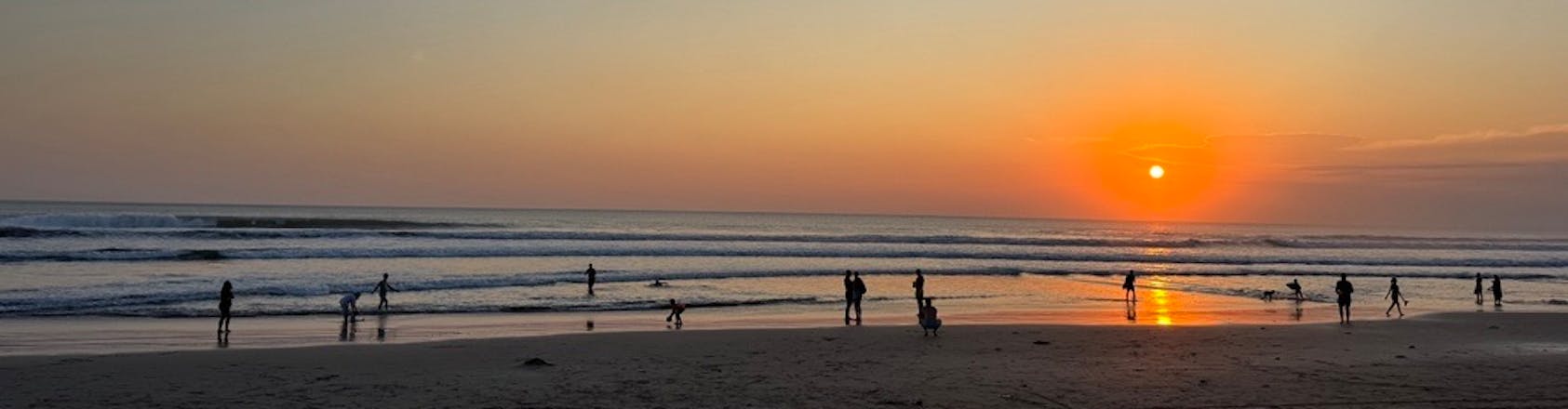 Beach in Legian, Bali at sunset People at sunset on the beach in Bali