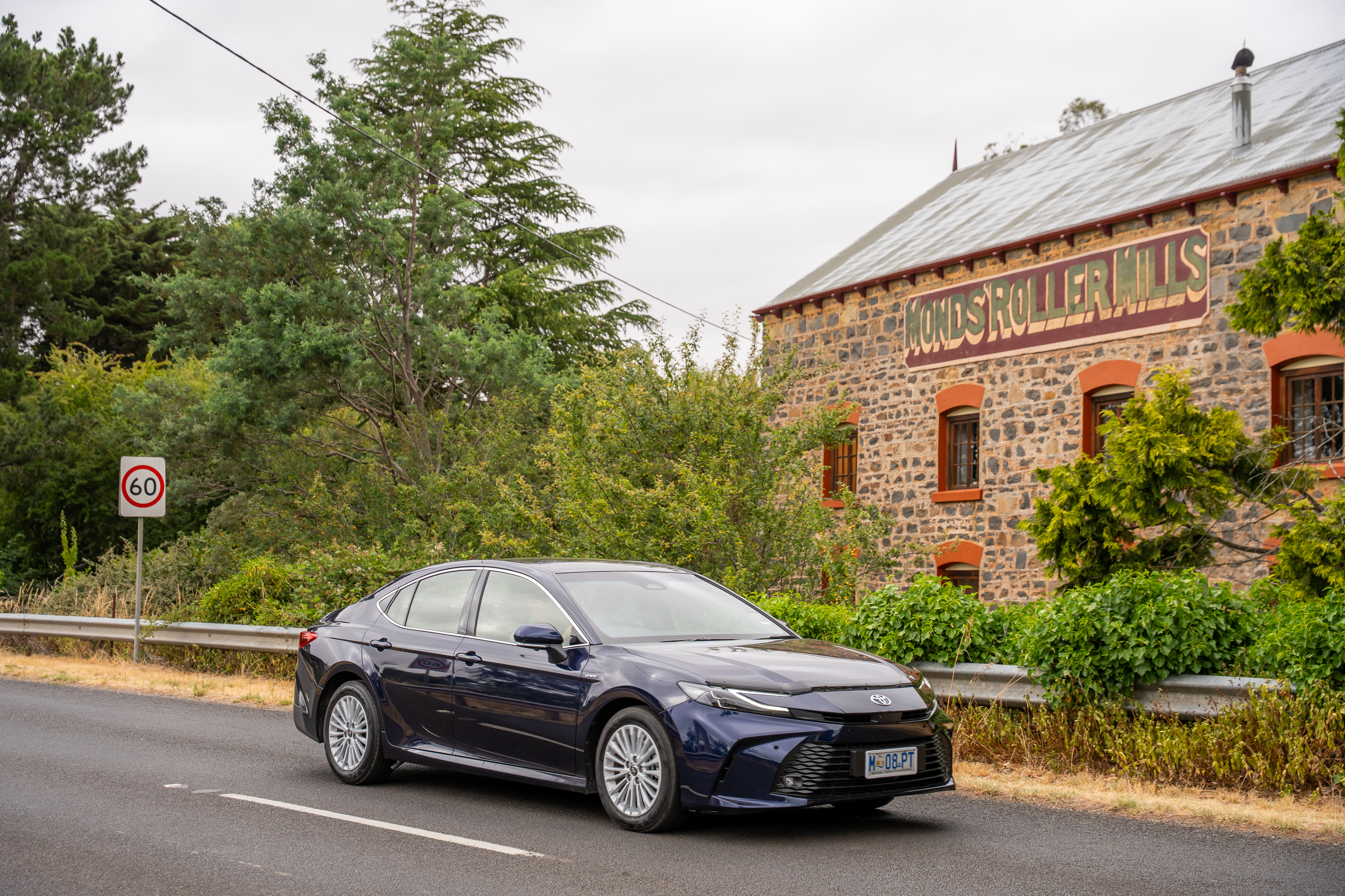 A Toyota Camry drives past an historic Tasmanian building
