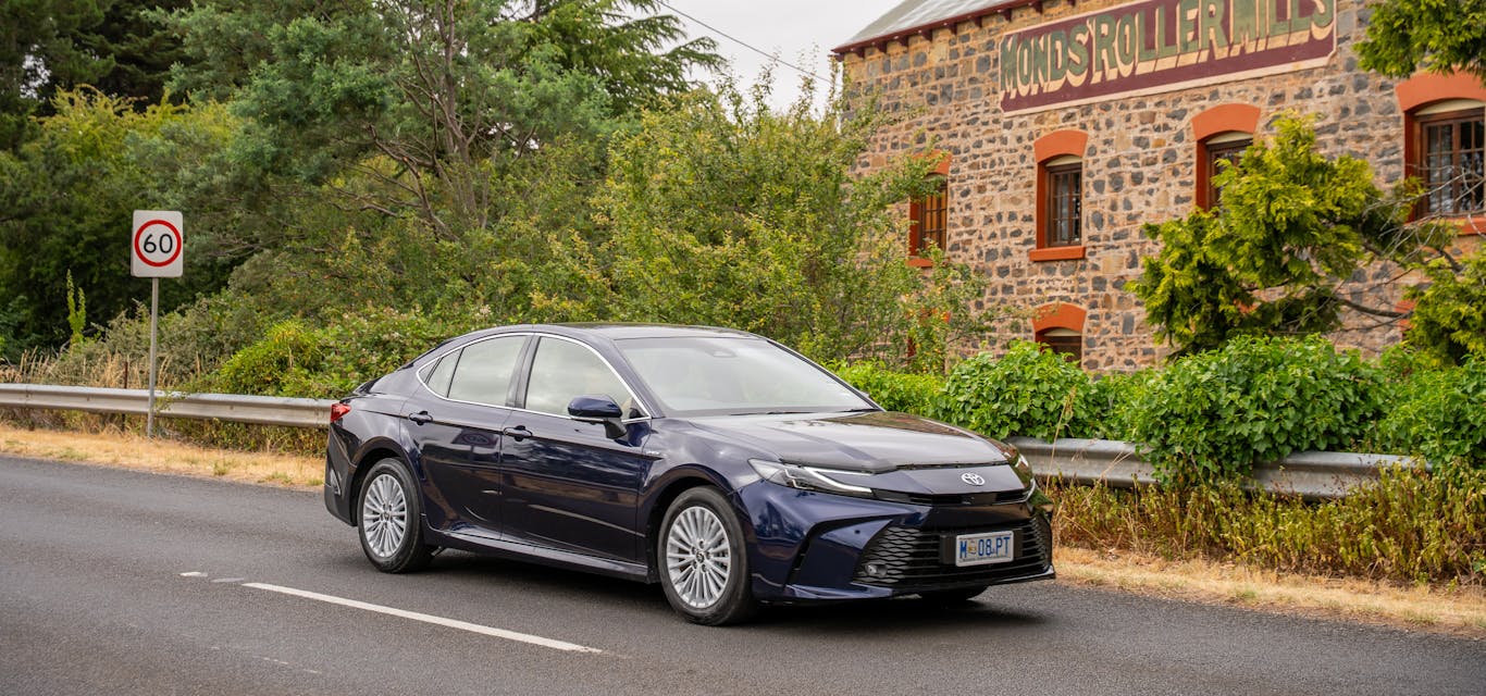 The Camry Ascent Sport A Toyota Camry drives past an historic Tasmanian building