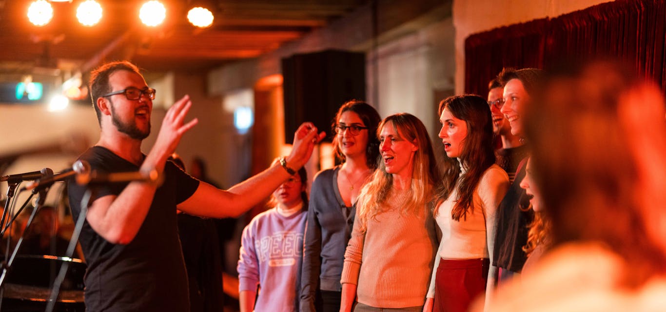 Everyone's a singer at the Festival of Voices A smiling man leads a group of people in song