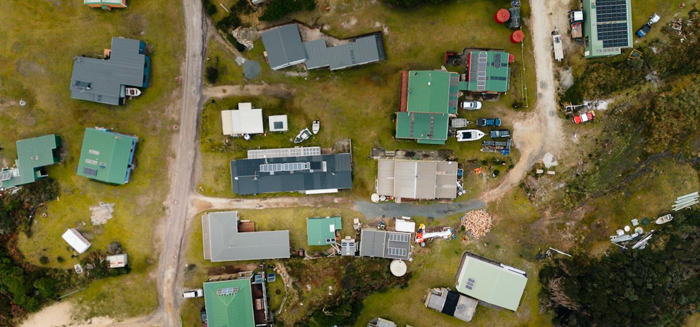 Trial Harbour, a small community on the West Coast An aerial shot of buildings, cars, caravans and boats in a small community on the West Coast of Tasmania