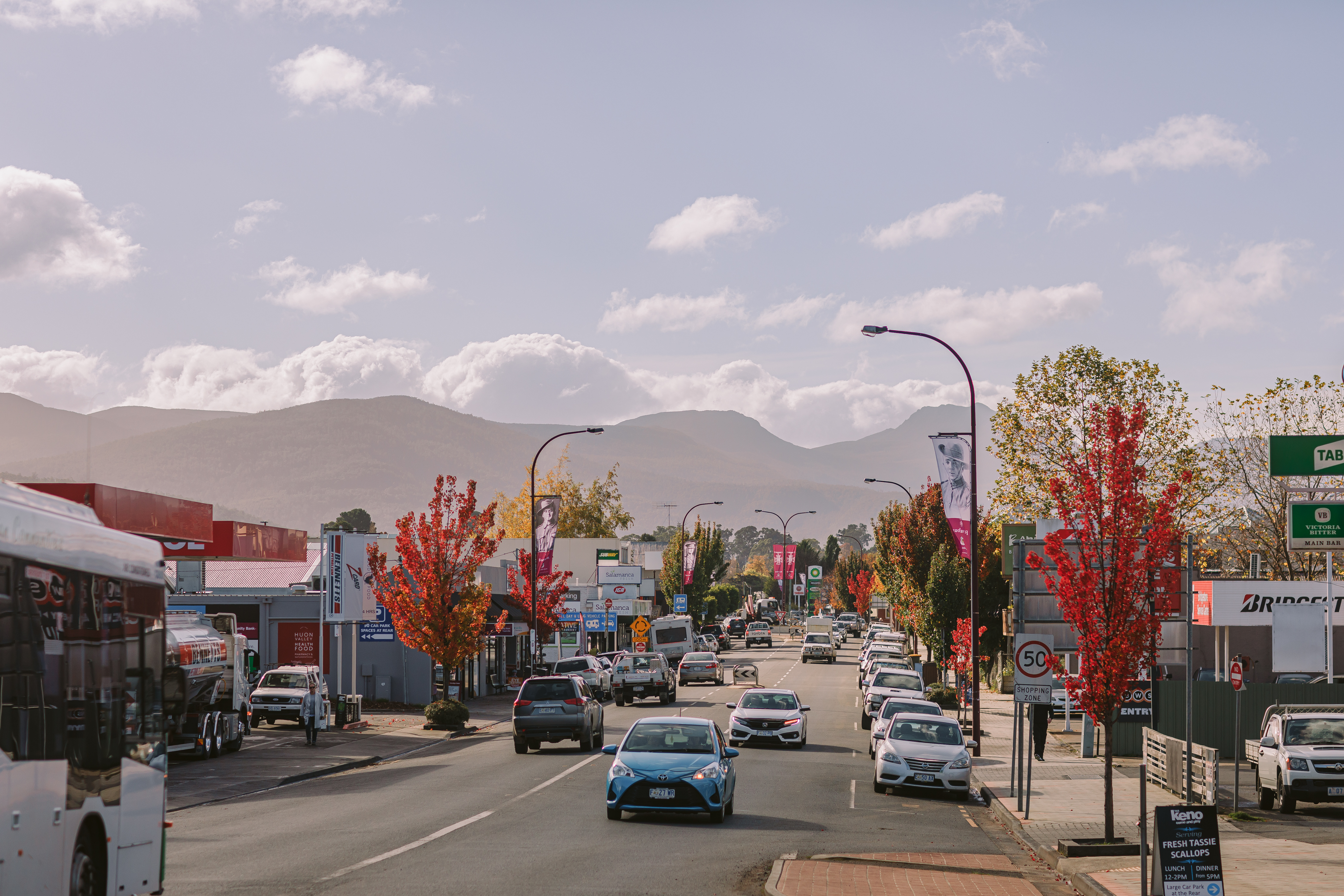 cars drive down the main street of Huonville