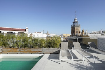 A picture of a pool and sunbeds in Seville 