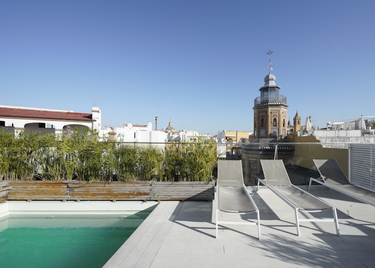 A picture of a pool and sunbeds in Seville