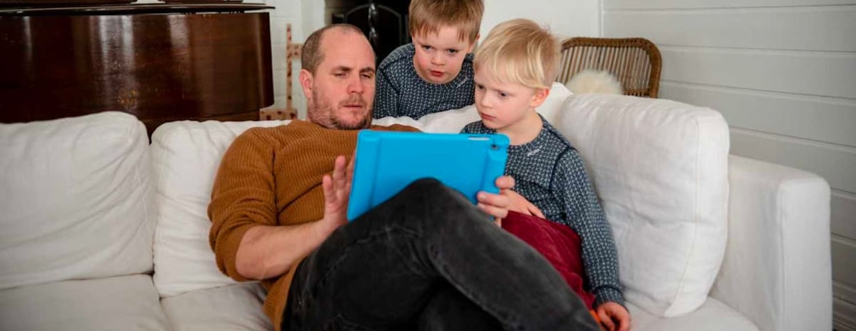 A father and two children solve math problems together