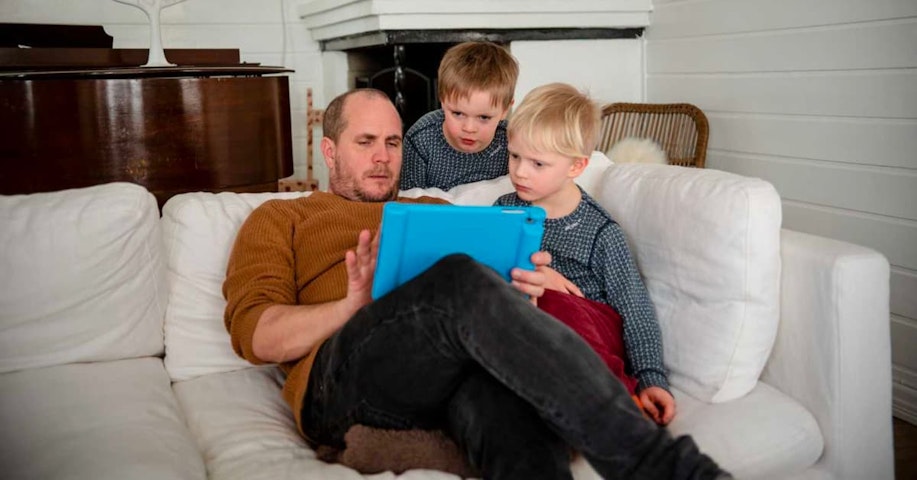 A father and two children solve math problems together