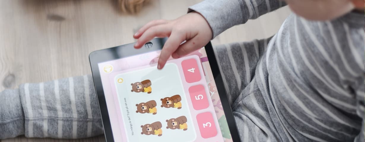 A child counts teddy bears