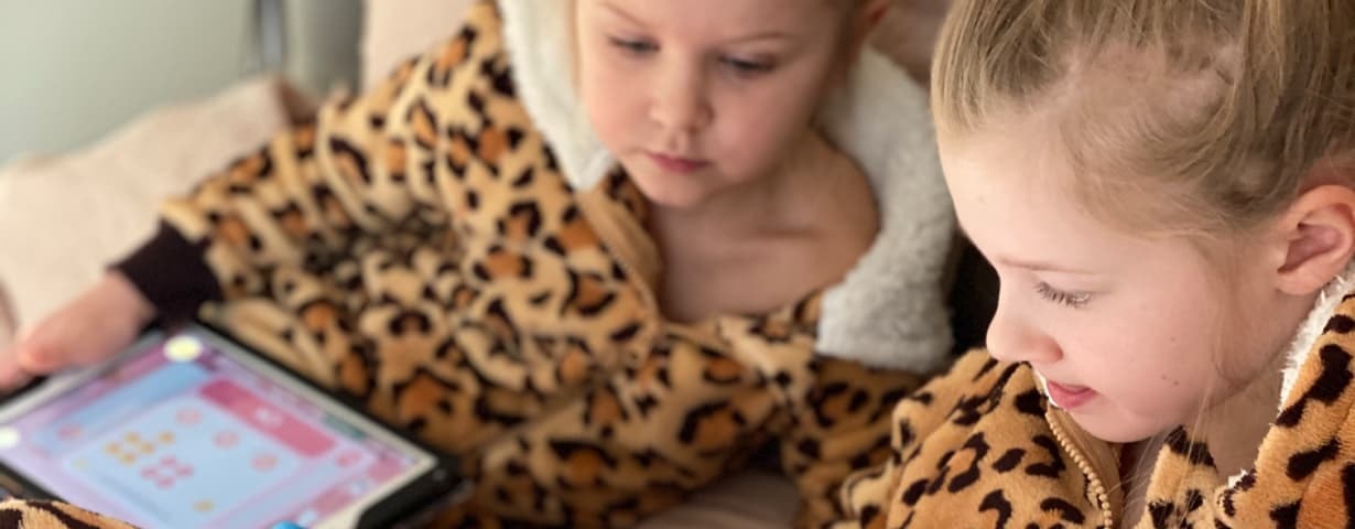 Two children collaborate on a math exercise