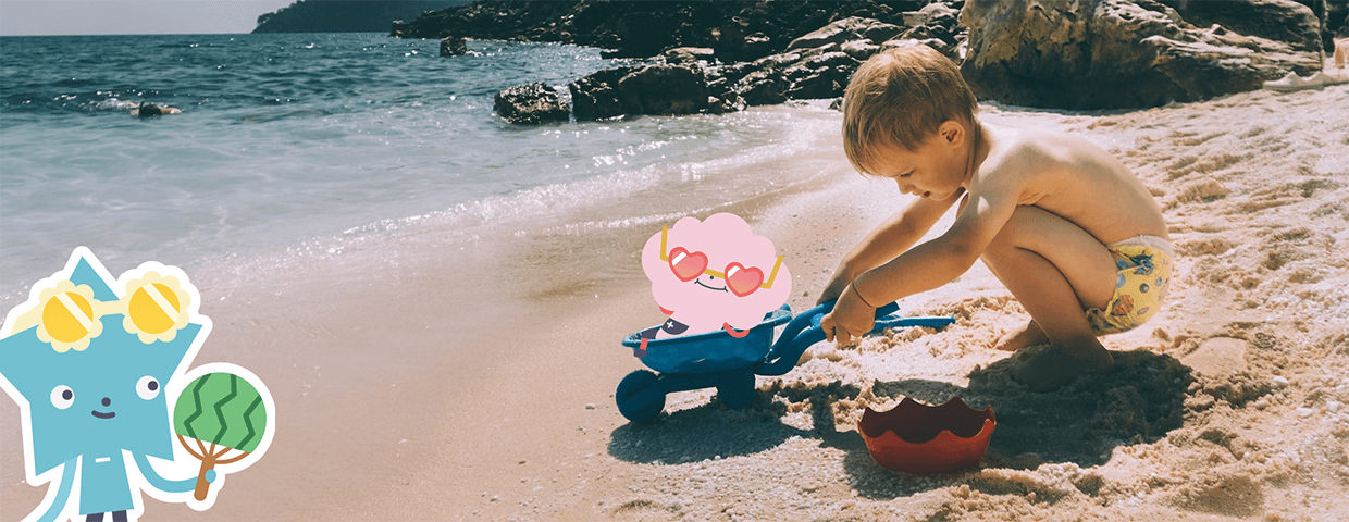 A child plays with the Albert's characters on the beach