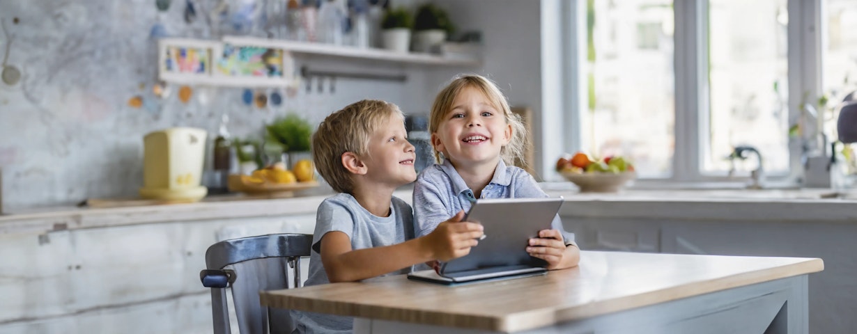 Happy children holding a tablet