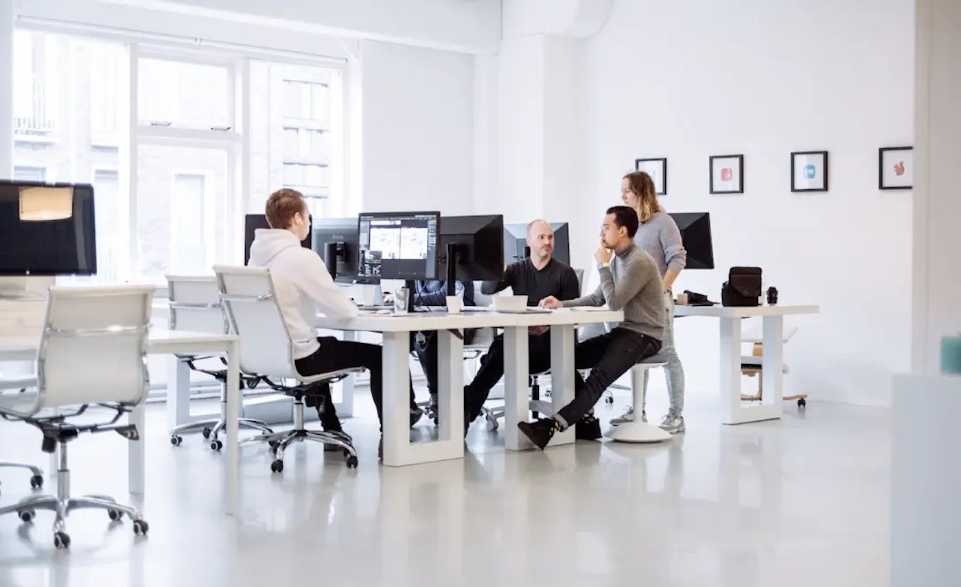 Shot of the Yummygum office, with teammembers discussing the Linkin Park