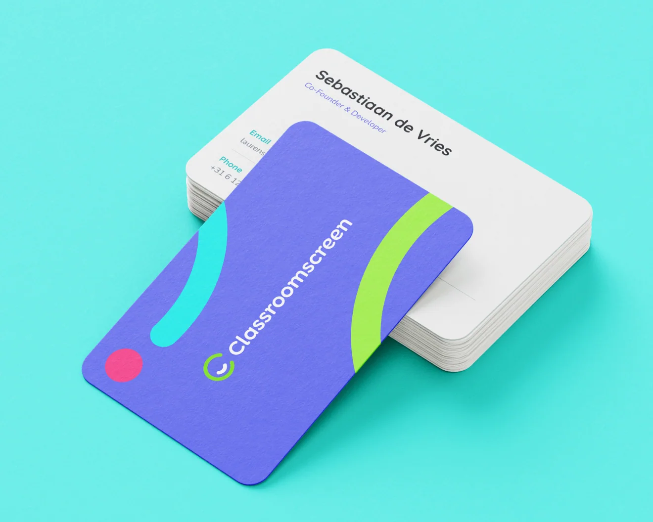 a Classroomscreen business card with the front showing, laying on a stack of Classroomscreen business cards with the rear showing